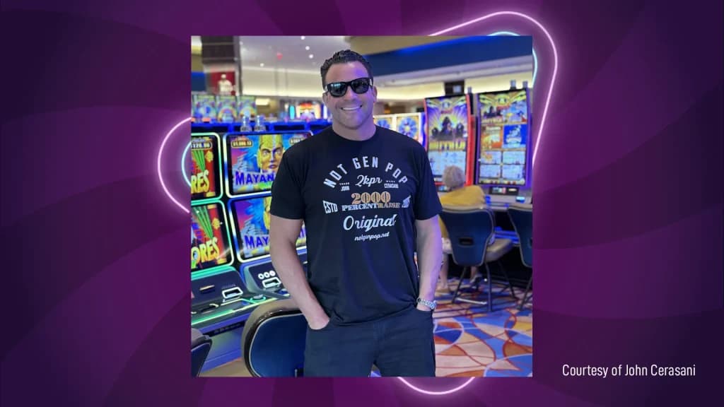 John Cerasani in a Not Gen Pop t-shirt standing on a casino floor surrounded by slot machines.