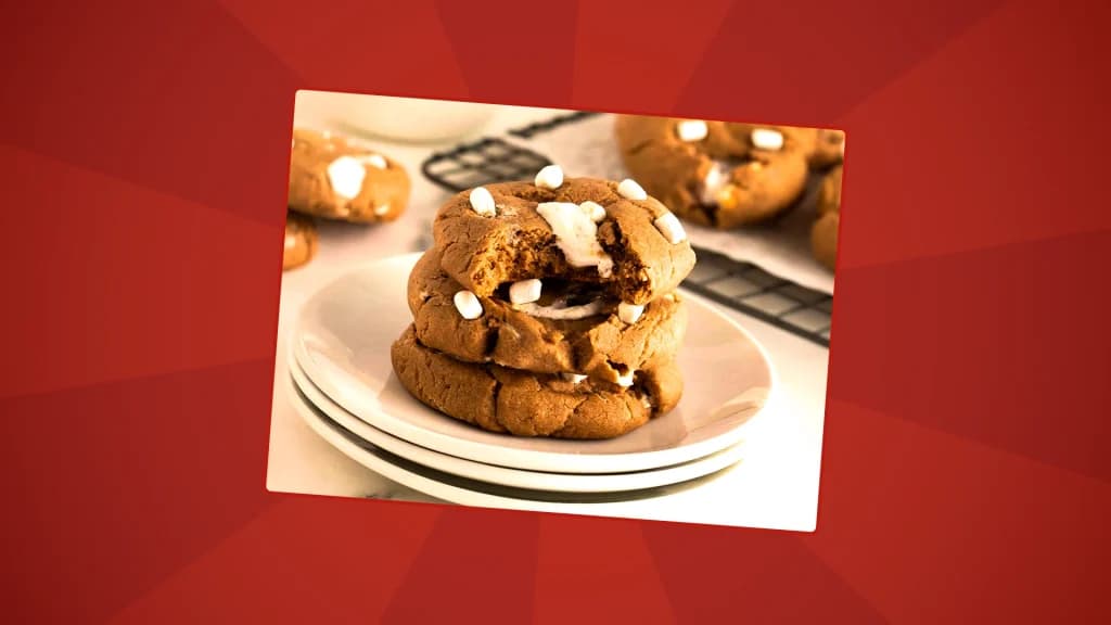 cookies inspired by hot chocolate are stacked on a plate with marshmallows on top