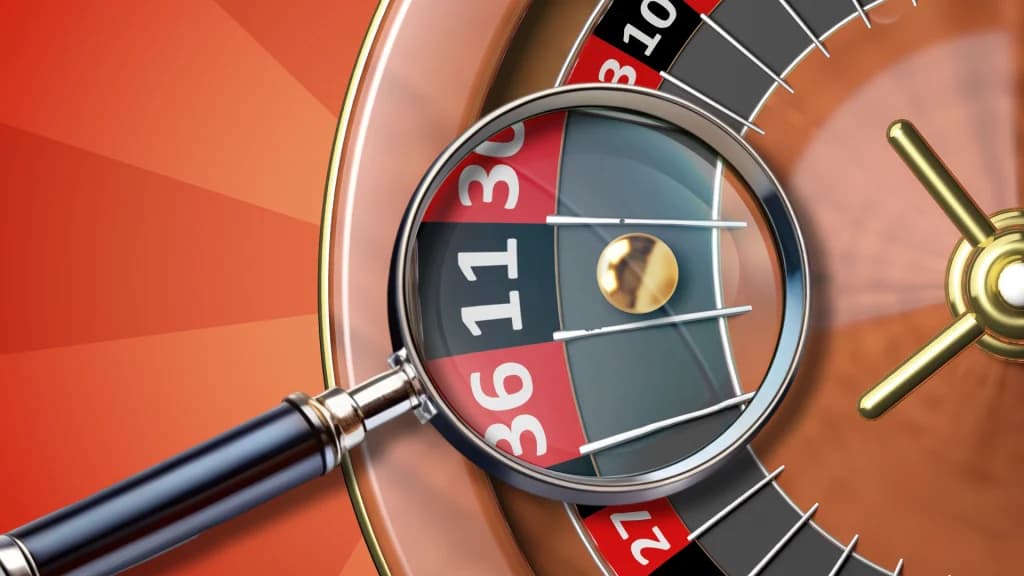 A magnifying glass highlights a gold roulette ball stopping over a divot on the wheel, demonstrating a wheel bias in roulette.