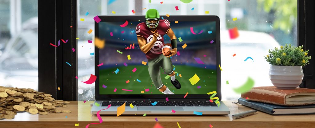 A MacBook sits on top of a counter bench in front of a window looking out to out-of-focus parked cars. A 3D-animated gridiron player is pictured running out of the laptop screen, surrounded by confetti. To the left is a pile of coins, and to the right is a pile of books propping up a small plant.