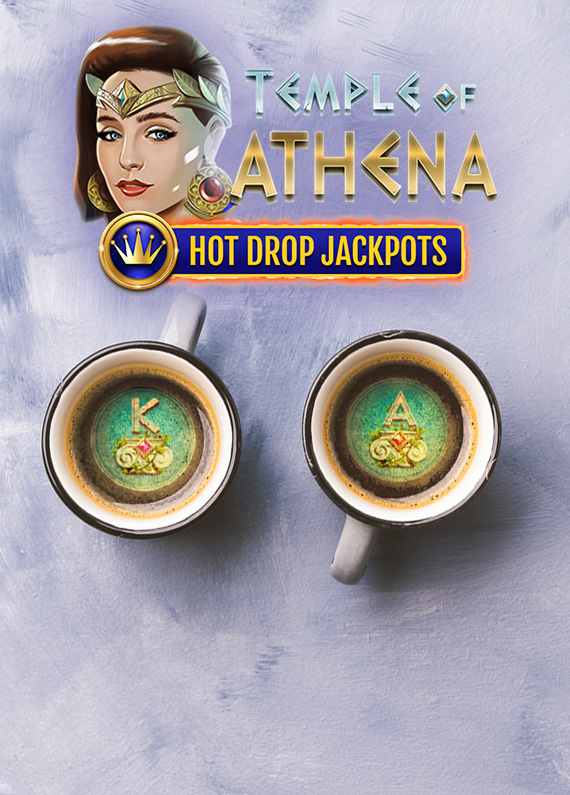 The main logo from the Cafe Casino slot game, Temple of Athena Hot Drop Jackpots, appears at the top center of the image. Sitting below atop an off-white table surface are two coffee mugs filled with coffee, each dusted with green sprinkles revealing two slots symbols including the letters A and K, respectively.