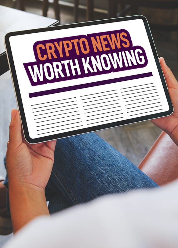 A person wearing blue denim jeans sits on a bench seat inside a diner, holding an iPad up which is showing a news site with the headline “Crypto News Worth Knowing”.