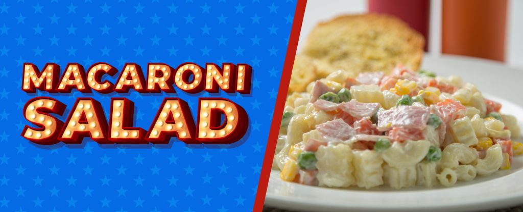 On the left, an illustrated Vegas-style sign saying "Macaroni Salad" against a Memorial Day-colored background with blue stars; while on the right, a photo showcases a white bowl filled with macaroni salad and a slightly blurred bread slice in the background.