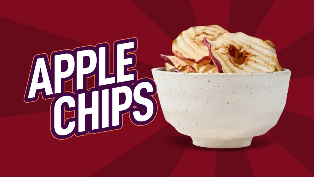 A ceramic bowl filled with crinkled apple chips with the text ‘apple chips’ is set against a maroon background.