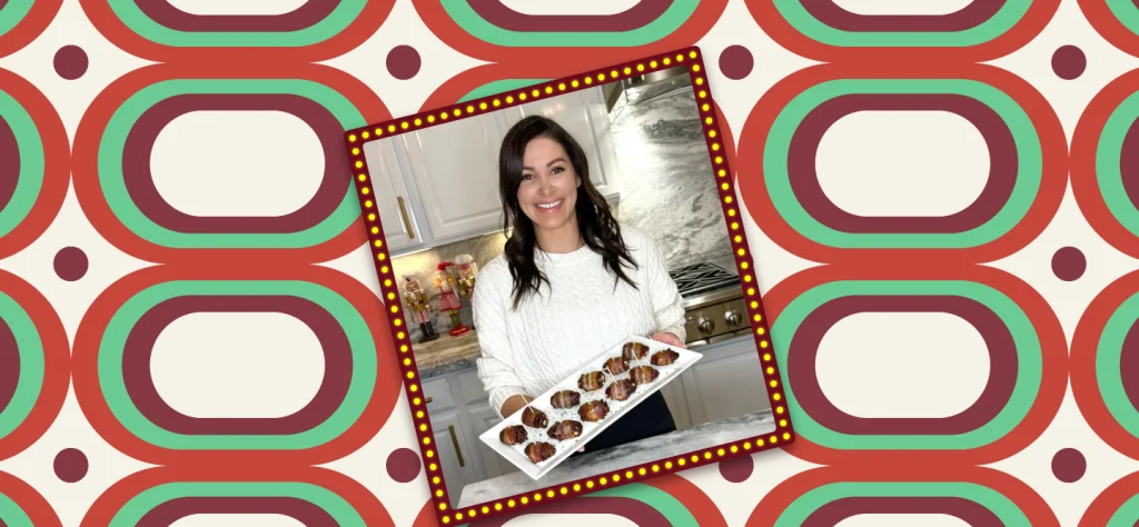 Chef Genevieve stands in a kitchen in a white sweater, holding a white dish with the easy holiday appetizer for bacon-wrapped dates stuffed with goat cheese and almonds.