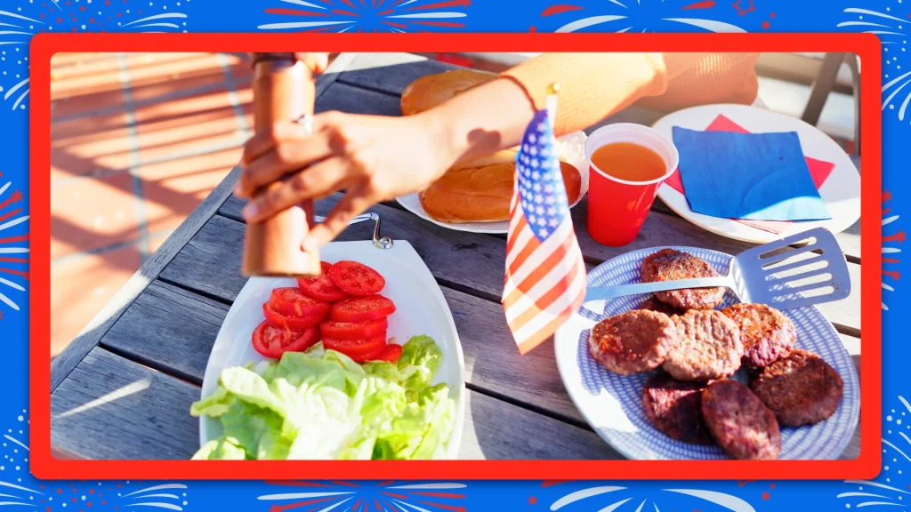 An image of a person hands adding black pepper to plate of hamburger ingredients