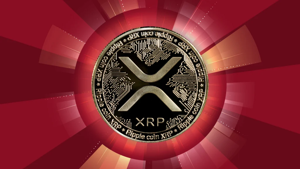 A shiny coin says “XRP,” and it’s in the center of a dark red background with a shadow circle illuminating white light.  