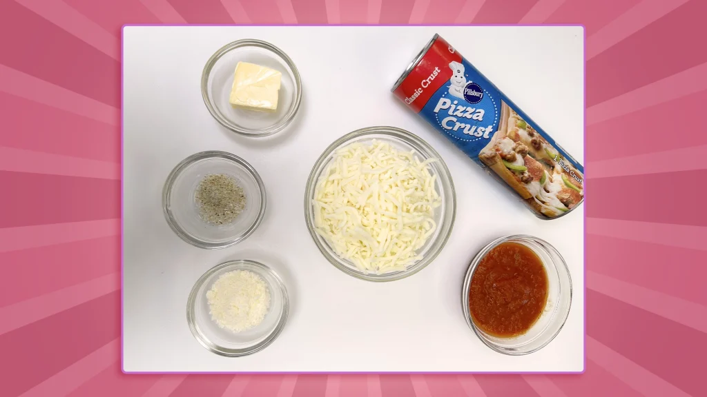 ingredients laid out: pizza dough, mozzarella, marinara sauce, butter, garlic salt, parmesan and parsley flakes