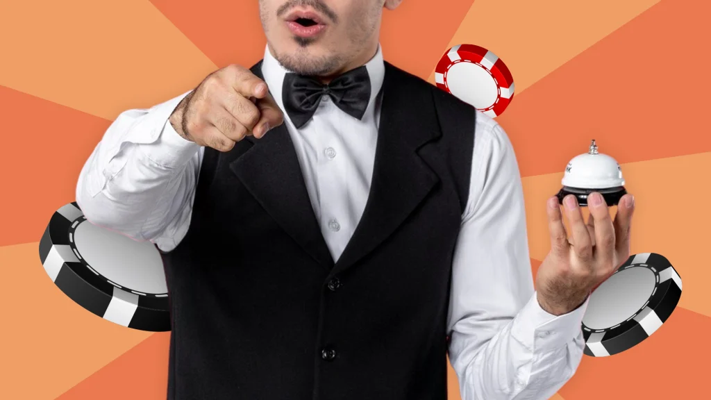 In a peach picture, a dealer in a black and white tux holds a call bell in his left hand and points to the front of the image. Behind him are two black and one red betting chips.