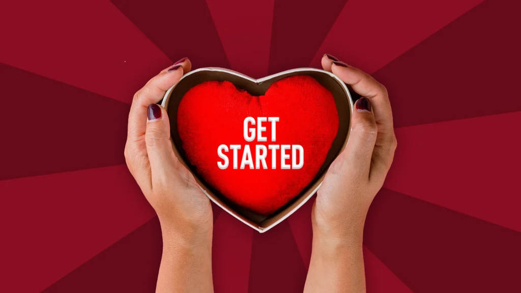 A loveheart cushion in a box cupped by hands with text "Get Started"