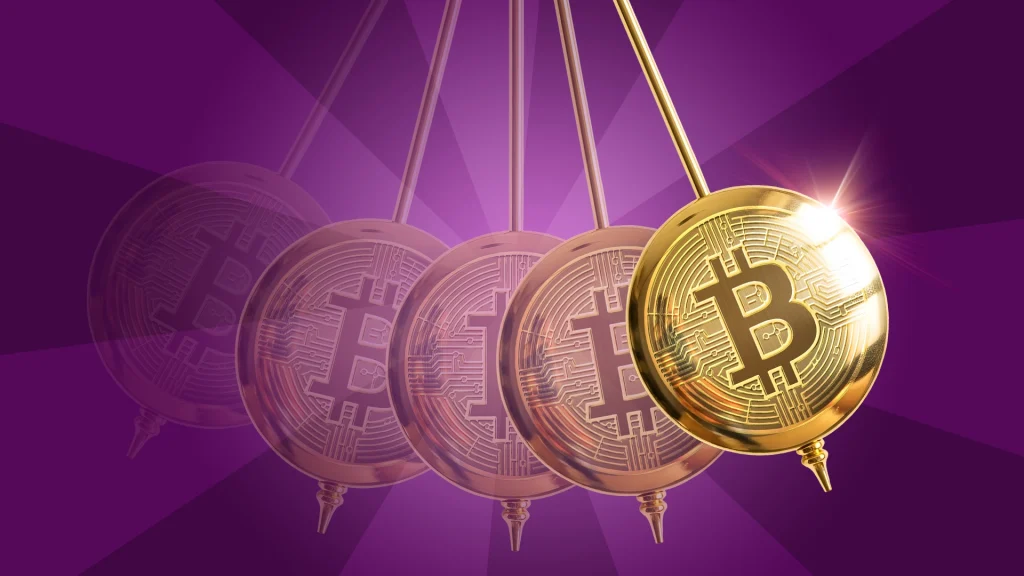 On a dark purple background, a gold pendulum with the bitcoin logo stamped on the front swings back and forth. 