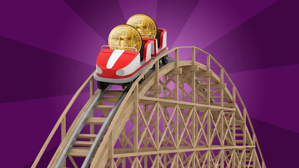 
Image 3: A red and white rollercoaster car rounds the peak and begins its descent with two gold bitcoins riding along. 
