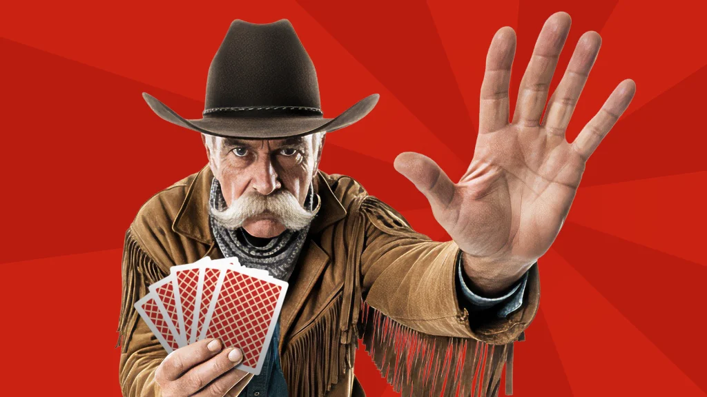 An old cowboy puts up a hand to say “stop” while holding five red cards in his other hand. It’s all shown on a red background. 