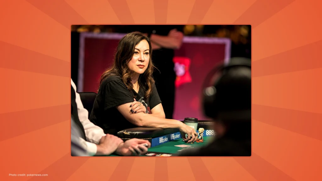 Jennifer Tilly sitting at a poker table, focused on the game, with chips and cards in front of her.